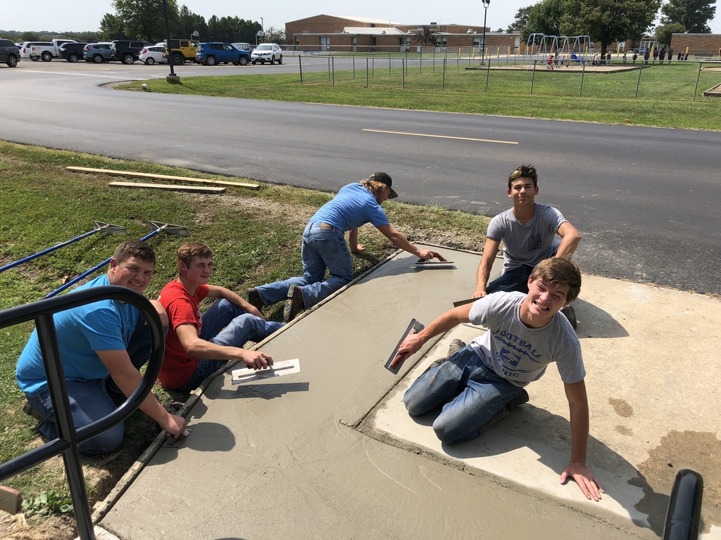 Mr. Owen and his construction skills class working on the sidewalk